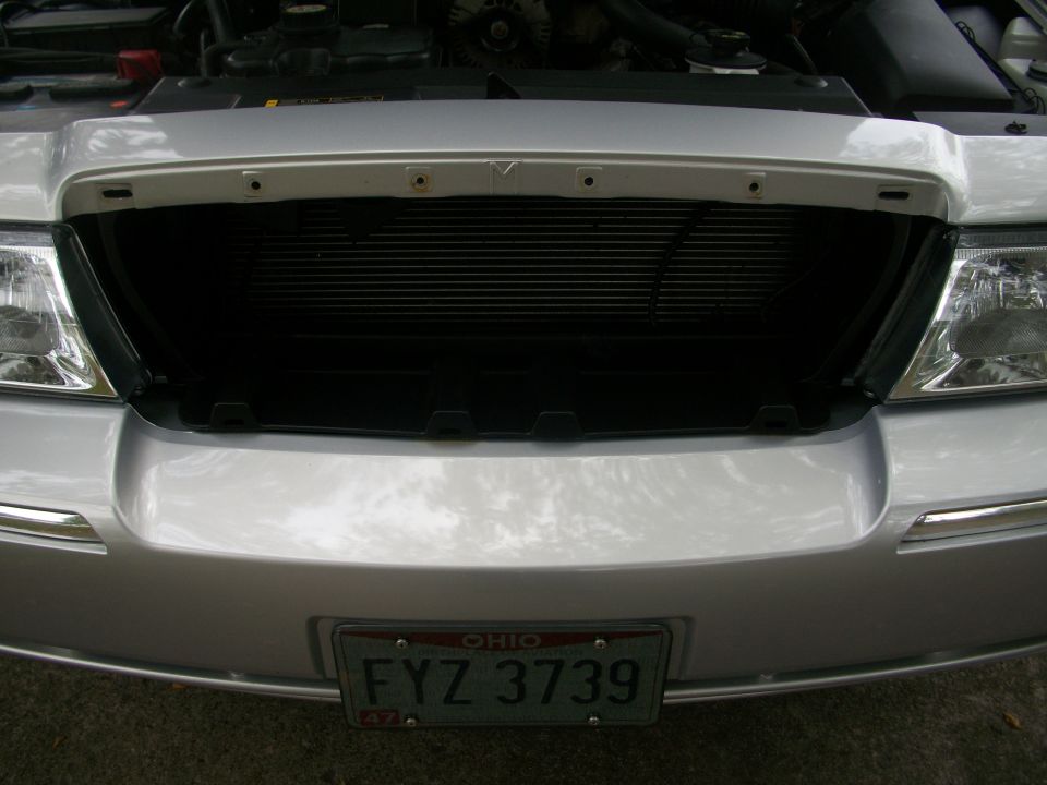 Silver sedan front end with hood open, showing the grille and headlights. License plate FYZ 3739