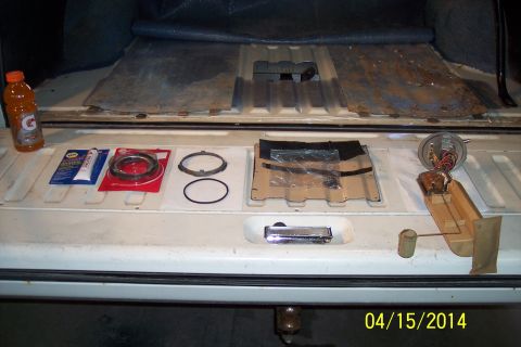 1990 Ford Bronco - Parts laid out on a tailgate, including a fuel pump assembly and gasket kit.