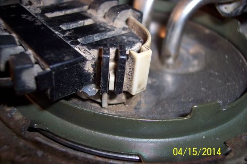1990 Ford Bronco - Fuel pump assembly connector detail, showing plastic clips and metal components.