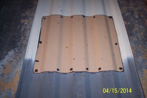 1990 Ford Bronco - A tan, corrugated metal panel with a cutout is shown, attached to a blue corrugated surface.