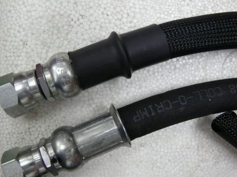 Two crimped hydraulic hose ends with fittings, Coll-O-Crimp text