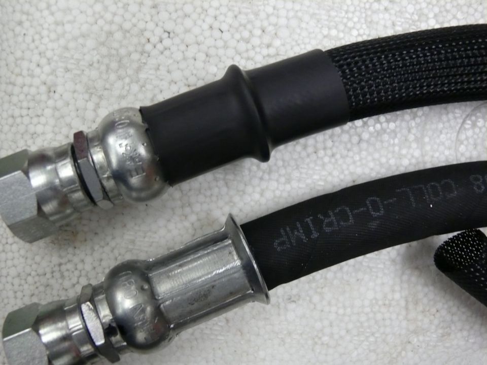 Two crimped hydraulic hose ends with fittings, Coll-O-Crimp text