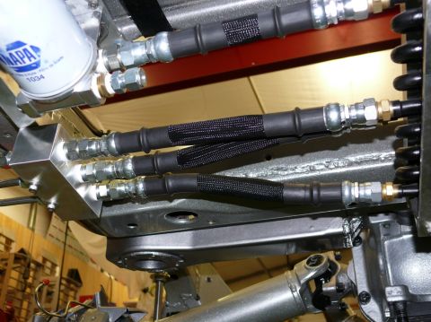 Underbody view of braided brake lines and NAPA oil filter