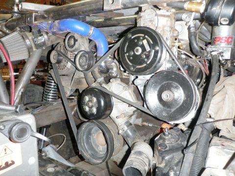 1961 International Scout 800 - Close-up view of a modified engine bay, highlighting the complex belt and pulley system.