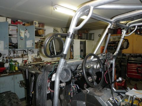 1961 International Scout 800 - The interior of a custom-built off-road buggy is shown in a workshop setting.