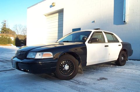 1991 Ford Crown Victoria LTD - This police car has a two-tone paint scheme and is parked on a snowy surface.
