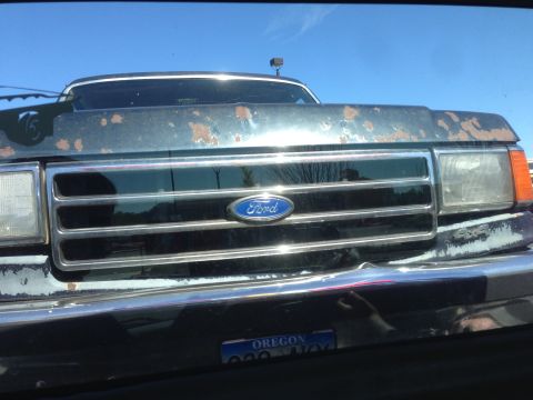 1990 Ford Bronco - Front view of a 1990 Ford Bronco, showing the grille and Ford emblem.