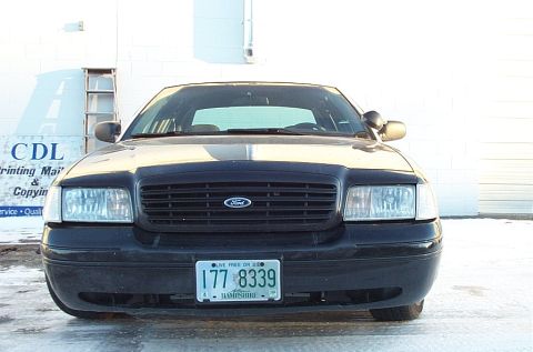 1991 Ford Crown Victoria LTD - Front view of a black Ford Crown Victoria with a license plate from New Hampshire.