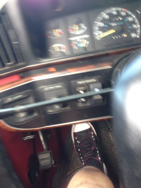 1989 Ford Bronco - Interior view of a vehicle, showing the driver's foot on the gas pedal and part of the dashboard.