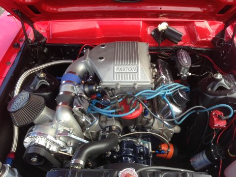 1989 Ford Bronco - Close-up of a custom engine bay a Paxton supercharger and vibrant blue spark plug wires.