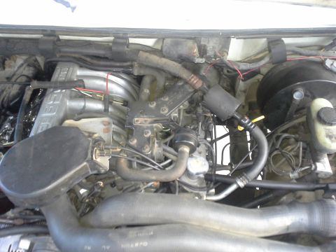 1991 Ford F-250 - Close-up view of the engine compartment, showing intricate mechanical details and wiring.