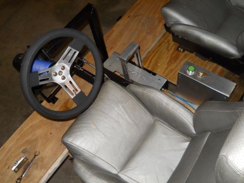 1992 Ford Bronco - Components of a racing simulator cockpit, including seats, steering wheel, and shifter.