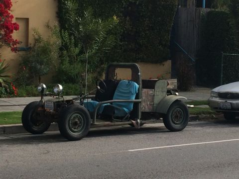 1968 Ford Mustang - A custom-built dune buggy with a weathered exterior sits parked on a street.