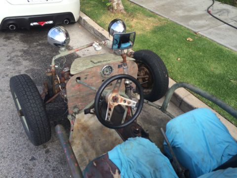 1968 Ford Mustang - A homemade go-kart with a rudimentary design sits parked on a street.