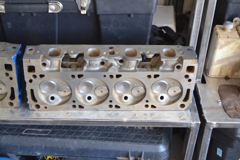 1981 Ford F-250 - A close-up view of an engine cylinder head, showing the intake and exhaust valves and ports. Some cast-in text is visible.