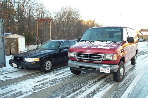 1991 Ford Crown Victoria LTD - Two Ford vehicles, a Crown Victoria and an Econoline van, are parked on a snowy road.
