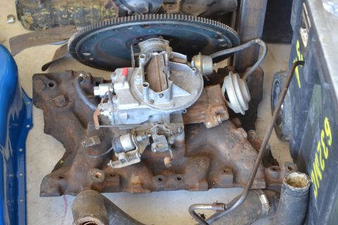 1981 Ford F-250 - Engine intake manifold with carburetor and flywheel visible, part of a larger assembly.