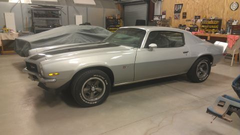 1976 Pontiac Trans Am - Silver 1976 Pontiac Trans Am parked in a garage next to a covered vehicle.