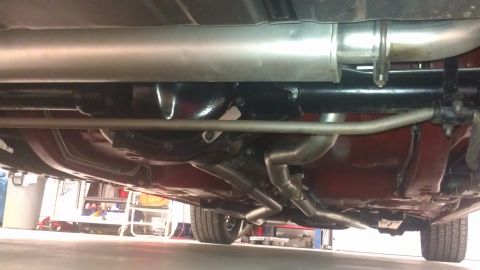 1976 Pontiac Trans Am - The underside of a vehicle is captured, revealing its exhaust and suspension parts.