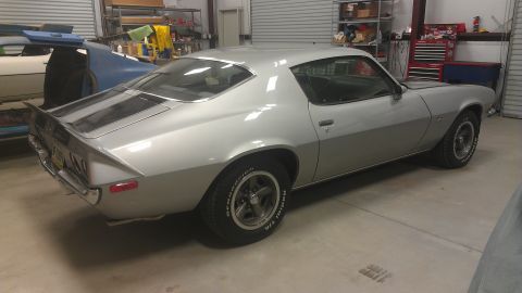 1976 Pontiac Trans Am - Silver 1975 Pontiac Firebird is parked in a garage next to another vehicle.