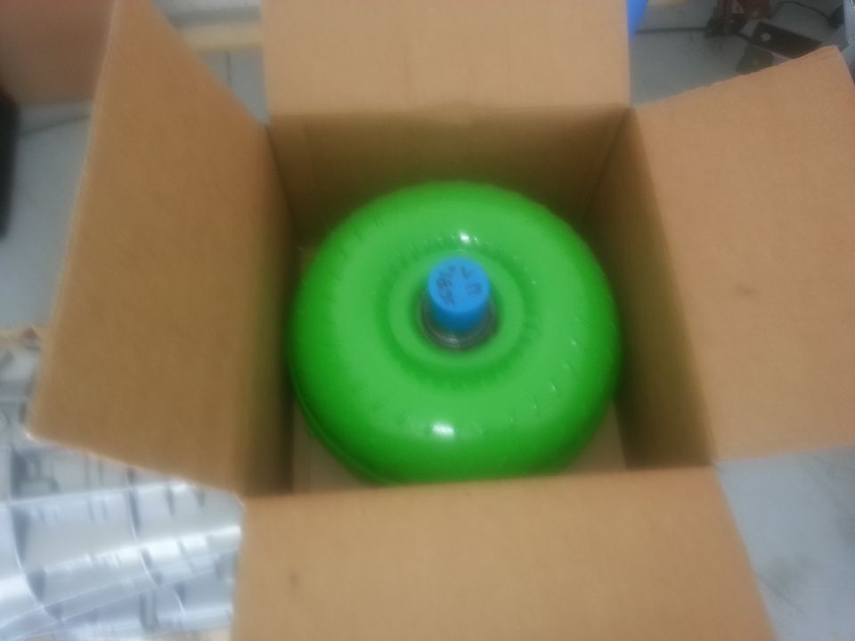 Green torque converter in a cardboard box