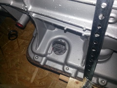 1994 Ford Bronco - Close-up view of a transmission sensor connector mounted on a gray metal housing.