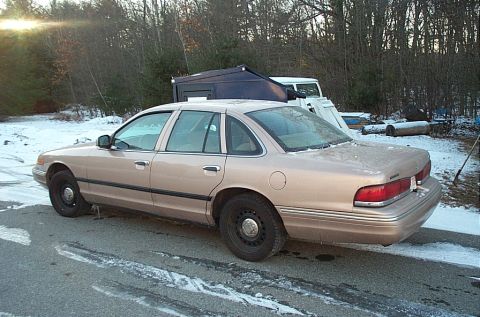 1991 Ford LTD Crown Victoria - A tan 1991 Ford Crown Victoria LTD sedan is parked on a road with snow on the ground.