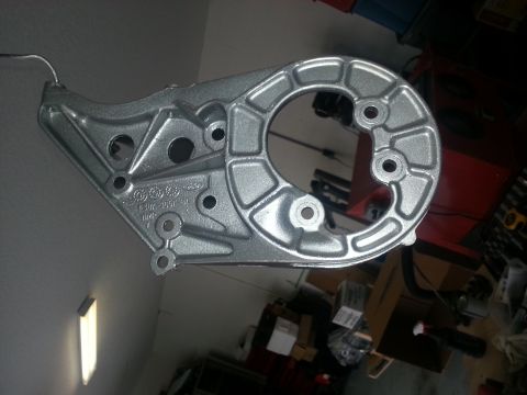 1994 Ford Bronco - A metal bracket, possibly for an alternator, is shown with stamped Ford markings and part numbers.