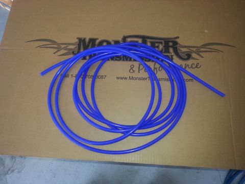 1994 Ford Bronco - Blue tubing is coiled on a cardboard box with "Monster Transmission & Performance" branding visible.