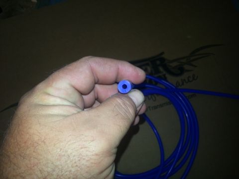 1994 Ford Bronco - A blue vacuum line is shown, with text on a box in the background reading 'SUPERMOTORS.NET'.