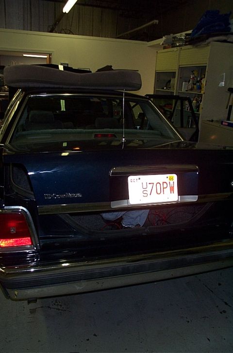 1991 Ford LTD Crown Victoria - Trunk of a 1991 Ford Crown Victoria LTD, showing the license plate and some items inside.