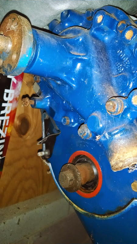 1979 Ford F-150 - A close-up view of a blue engine part with visible rust and a seal.