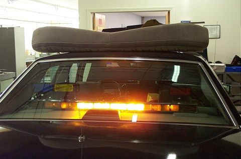 1991 Ford LTD Crown Victoria - Interior view of a 1991 Ford Crown Victoria LTD with a light bar installed and a cushion on the roof.