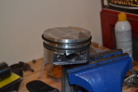 1981 Ford F-250 - Engine piston secured in a vise, ready for assembly or inspection.