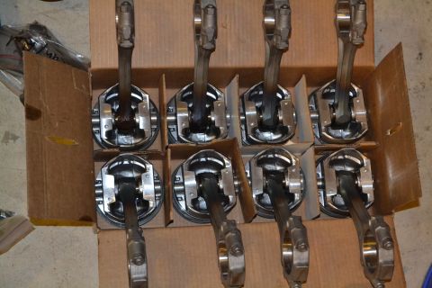1981 Ford F-250 - A set of engine pistons and connecting rods are neatly arranged in a box, ready for installation or storage.