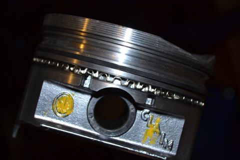 1981 Ford F-250 - Close-up of a vehicle piston, showing wear and markings.