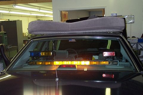 1991 Ford LTD Crown Victoria - The interior of a vehicle is shown, equipped with a light bar and emergency lights.