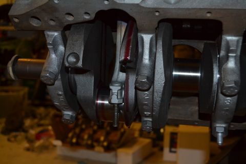 1981 Ford F-250 - Close-up view of an engine's crankshaft and connecting rods during reassembly.