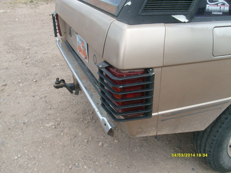 1991 Land Rover Range Rover rear bumper, taillight guards, and trailer hitch. Beige paint