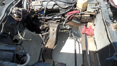 1972 Ford Ranchero - The engine bay of a vehicle is shown with various components and wiring exposed.