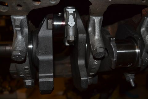 1981 Ford F-250 - Close-up view of a crankshaft, showing its intricate mechanical components and some visible part numbers.