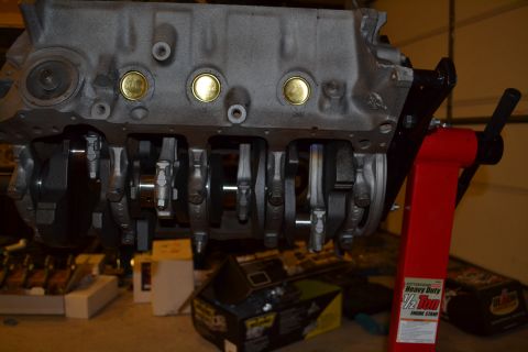 1981 Ford F-250 - Engine block assembly with crankshaft and connecting rods, mounted on a red engine stand.
