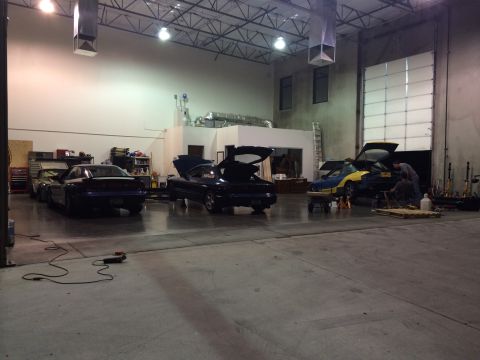 1995 Ford Probe - Multiple vehicles are present in a garage, with some undergoing maintenance.