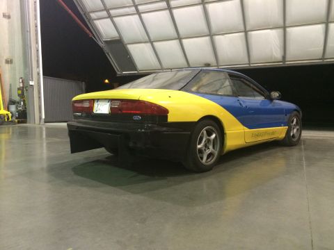 1995 Ford Probe - This 1995 Ford Probe features a distinctive blue and yellow paint scheme, seen here from the rear three-quarter angle.