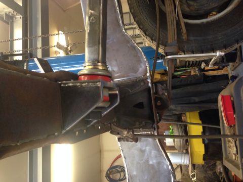 1993 Ford Bronco - Detail view of suspension and frame work, showing red bushings and welded metal parts.