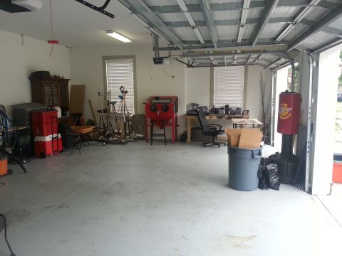 1994 Ford Bronco - Interior view of a garage filled with tools, storage, and a workbench.