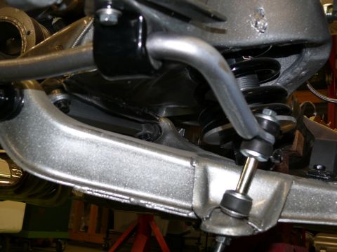 Close-up of a car's front suspension sway bar and linkage