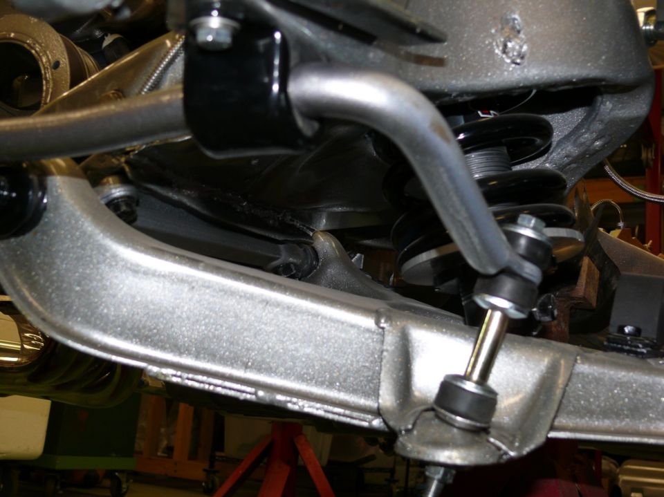 Close-up of a car's front suspension sway bar and linkage