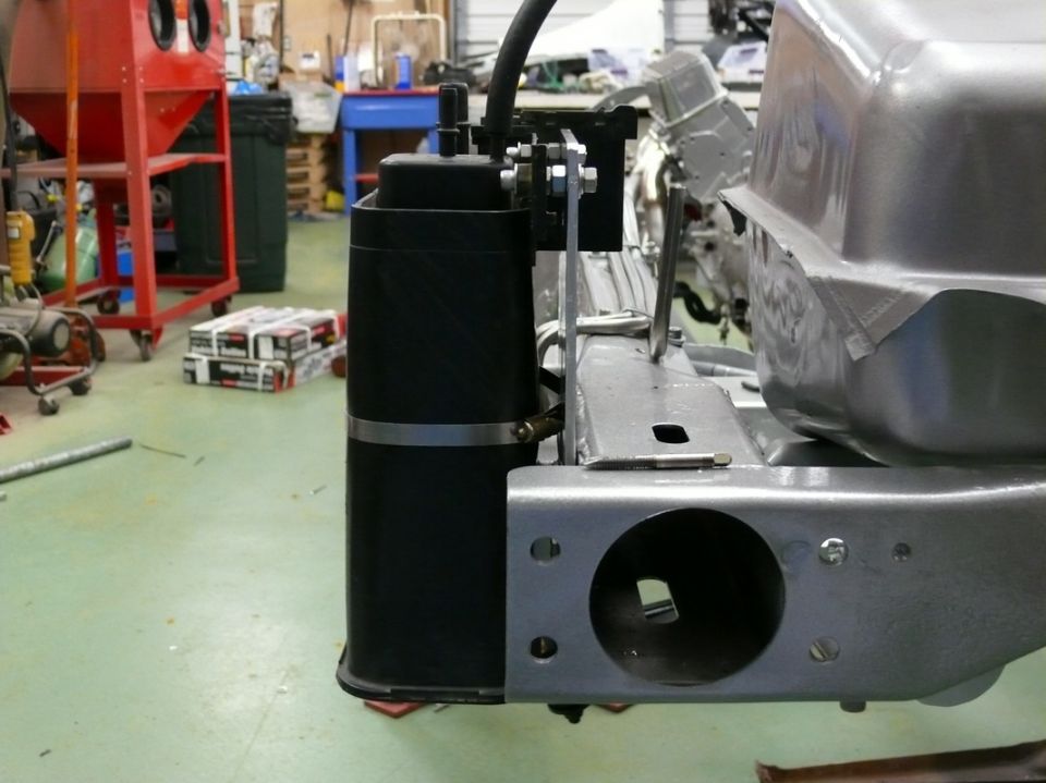 Car frame part with black canister and SuperMotors logo
