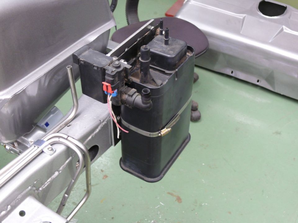 Evaporative emissions canister and fuel lines on a vehicle frame